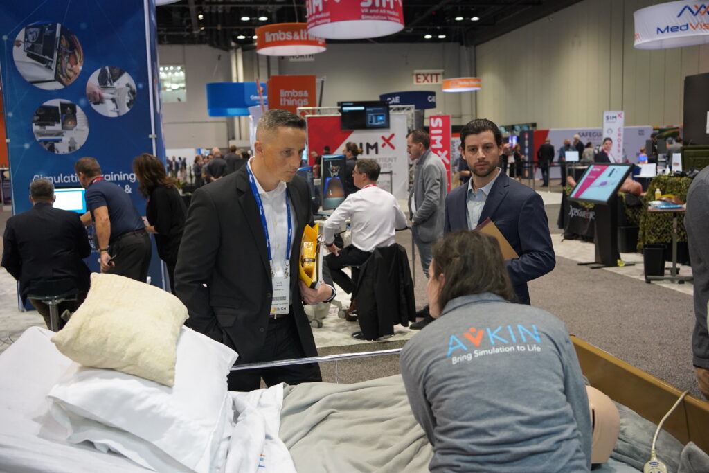 Avkin answering questions about their wearable simulators at IMSH 2023